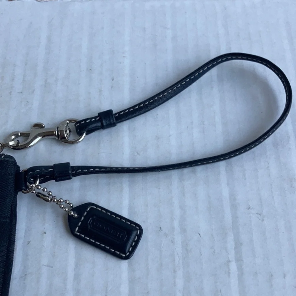 Coach black signature C mini wristlet.